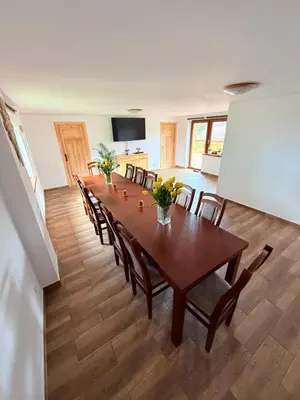 a dining room with a long table and chairs at Pod Lachowym Groniem in Koszarawa