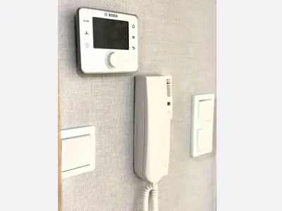 a wall with a cell phone and a charger at Jungle Apartment in Kraków