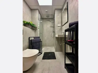 a bathroom with a shower and a toilet and a sink at Jungle Apartment in Kraków