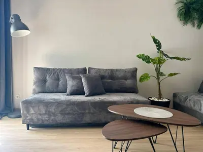 a living room with a couch and a table at Jungle Apartment in Kraków