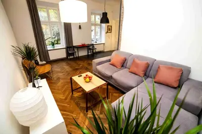 a living room with a couch and a table at Classic Loft Arena in Kraków
