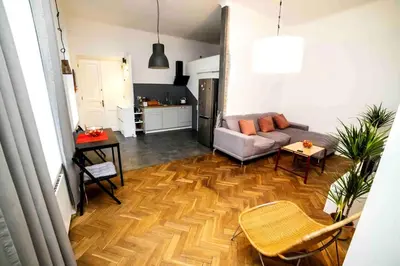 a living room with a couch and a table at Classic Loft Arena in Kraków