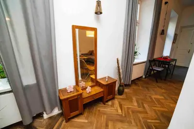 a hallway with a mirror and a wooden floor at Classic Loft Arena in Kraków