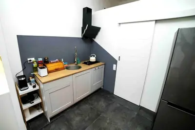 a small kitchen with a sink and a counter at Classic Loft Arena in Kraków
