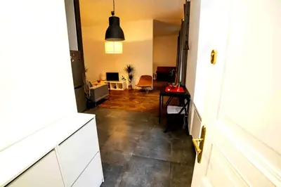 a room with a hallway with a living room at Classic Loft Arena in Kraków