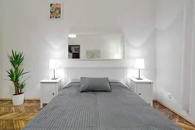 a bedroom with a large bed with two night stands at Old Town Apartment in Kraków