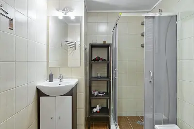 a bathroom with a sink and a shower at Old Town Apartment in Kraków