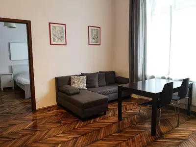 a living room with a couch and a table and a mirror at Old Town Apartment in Kraków