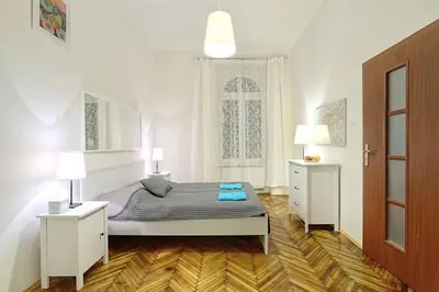 a bedroom with a bed and two night stands at Old Town Apartment in Kraków