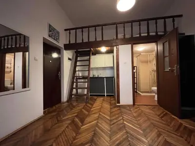 a room with a bunk bed and a kitchen at Old Town Apartment in Kraków
