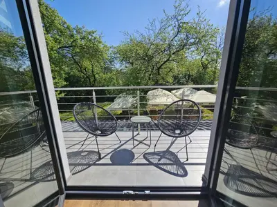 a view of a balcony with chairs and a table at Noclegi Primavera in Jaśkowice