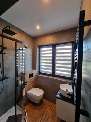 a bathroom with a toilet and a sink and a shower at Noclegi Primavera in Jaśkowice