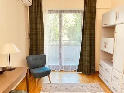 a room with a chair and a window at Four Apartaments Daszyńskiego in Kraków