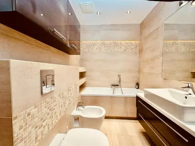 a bathroom with a toilet and a sink and a tub at Four Apartaments Daszyńskiego in Kraków