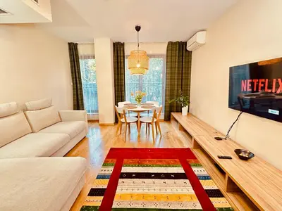 a living room with a couch and a table at Four Apartaments Daszyńskiego in Kraków