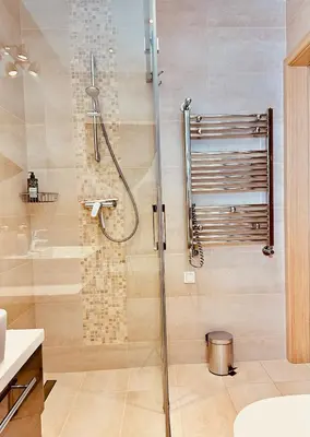 a shower with a glass door in a bathroom at Four Apartaments Daszyńskiego in Kraków
