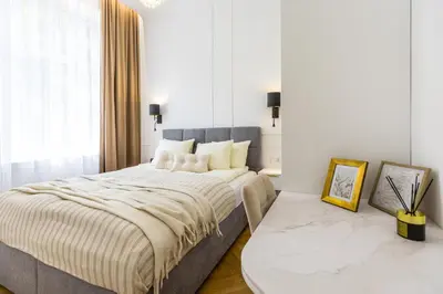a bedroom with a large bed and a window at BoB Elite - Bonerowska in Kraków