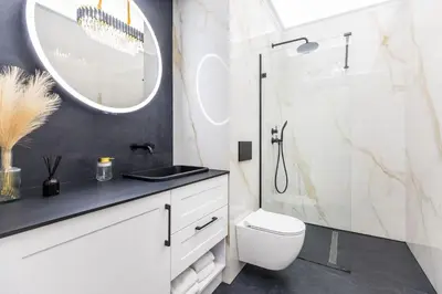 a bathroom with a toilet and a sink and a mirror at BoB Elite - Bonerowska in Kraków