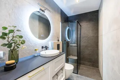 a bathroom with a sink and a mirror at BoB Elite - Bonerowska in Kraków