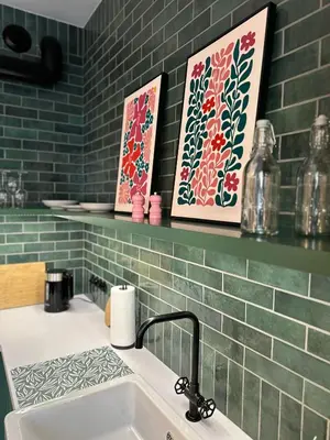 a bathroom with a sink and two paintings on a wall at Heron Apartment - Old Town Kraków in Kraków