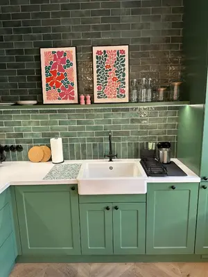 a kitchen with green cabinets and a sink at Heron Apartment - Old Town Kraków in Kraków
