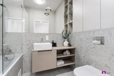 a white bathroom with a sink and a shower at Blue Blue Apartment in Kraków