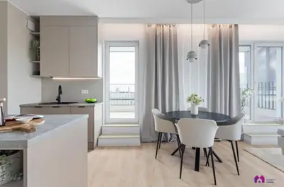 a kitchen and dining room with a table and chairs at Blue Blue Apartment in Kraków