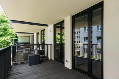 a balcony with sliding glass doors with a view of a building at Native Apartments Kościuszki 39I27 in Kraków