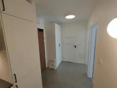 a bedroom with a bed and a room with a window at 2-Bedroom Apartment with 2 Free Parking Spots - TAURON ARENA in Kraków