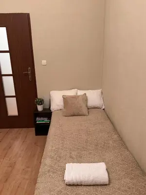 a room with a bed with two pillows on it at Enios Rooms Hostel Zwierzyniecka 6 in Kraków