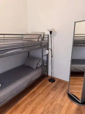 a room with two bunk beds and a lamp at Enios Rooms Hostel Zwierzyniecka 6 in Kraków