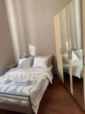 a bedroom with a bed and a mirror at Enios Rooms Hostel Zwierzyniecka 6 in Kraków