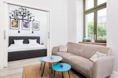a living room with a couch and two tables at Modern Nest - in the Heart of Kraków - Old Town - by Upstairs in Kraków