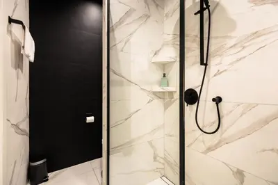 a shower with a glass door in a bathroom at Modern Nest - in the Heart of Kraków - Old Town - by Upstairs in Kraków