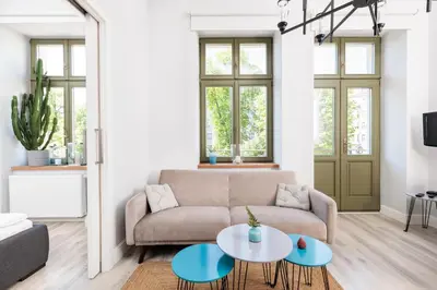 a living room with a couch and a table at Modern Nest - in the Heart of Kraków - Old Town - by Upstairs in Kraków