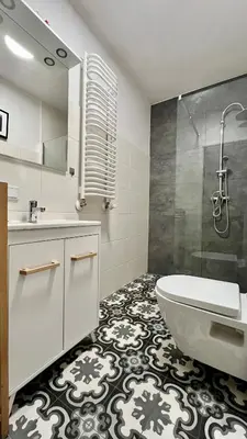 a bathroom with a tub and a sink and a shower at Small Studio in Kraków