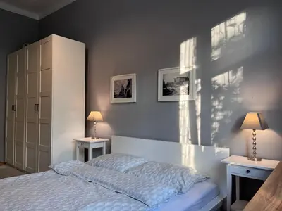 a bedroom with a bed with two night stands and two lamps at Wawel Castle! Central apartment in Kraków
