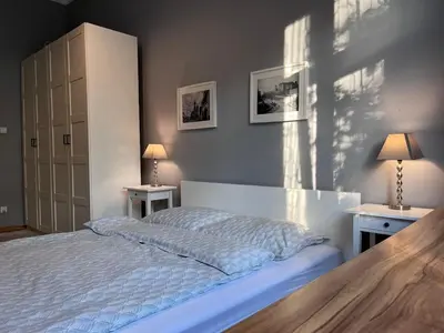 a bedroom with a bed with two tables and two lamps at Wawel Castle! Central apartment in Kraków