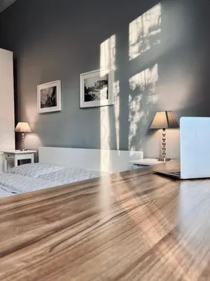 a bedroom with a bed and a cross on the wall at Wawel Castle! Central apartment in Kraków