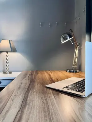 a laptop computer sitting on top of a wooden table at Wawel Castle! Central apartment in Kraków