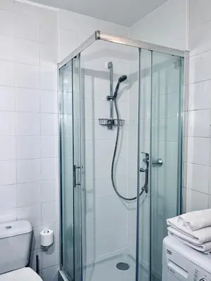 a bathroom with a glass shower with a toilet at Wawel Castle! Central apartment in Kraków