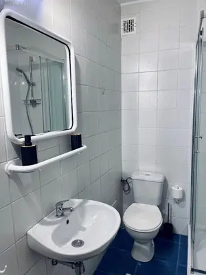 a white bathroom with a sink and a toilet at Wawel Castle! Central apartment in Kraków