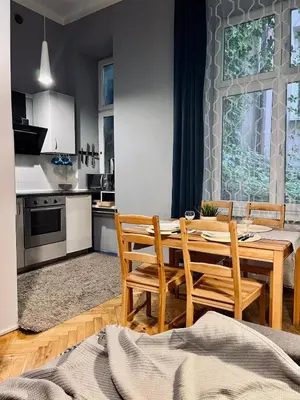 a kitchen and dining room with a wooden table and chairs at Wawel Castle! Central apartment in Kraków