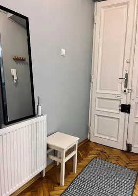 a room with a tv and a stool and a door at Wawel Castle! Central apartment in Kraków