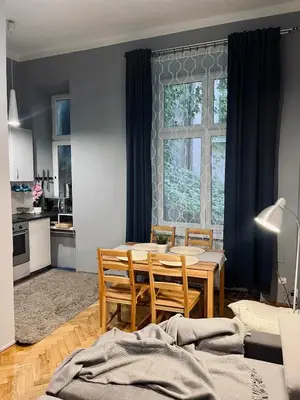 a kitchen and dining room with a table and chairs at Wawel Castle! Central apartment in Kraków