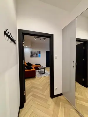 a hallway with a door leading to a living room at Old Town Libra Apartment in Kraków