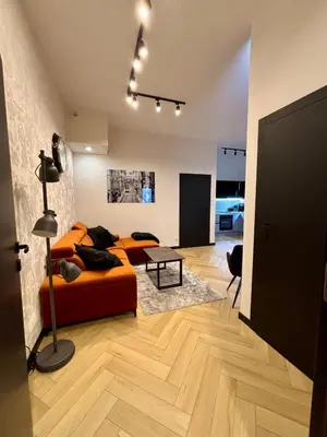 a bedroom with a bed and a living room at Old Town Libra Apartment in Kraków