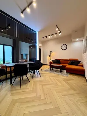 a living room with a couch and a table at Old Town Libra Apartment in Kraków