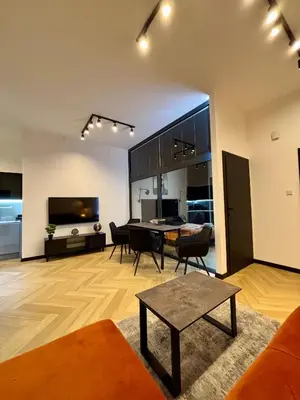a living room with a table and a dining room at Old Town Libra Apartment in Kraków