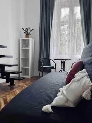 a bedroom with a bed and a piano and a table at Cosy apartment Heart of Krakow in Kraków